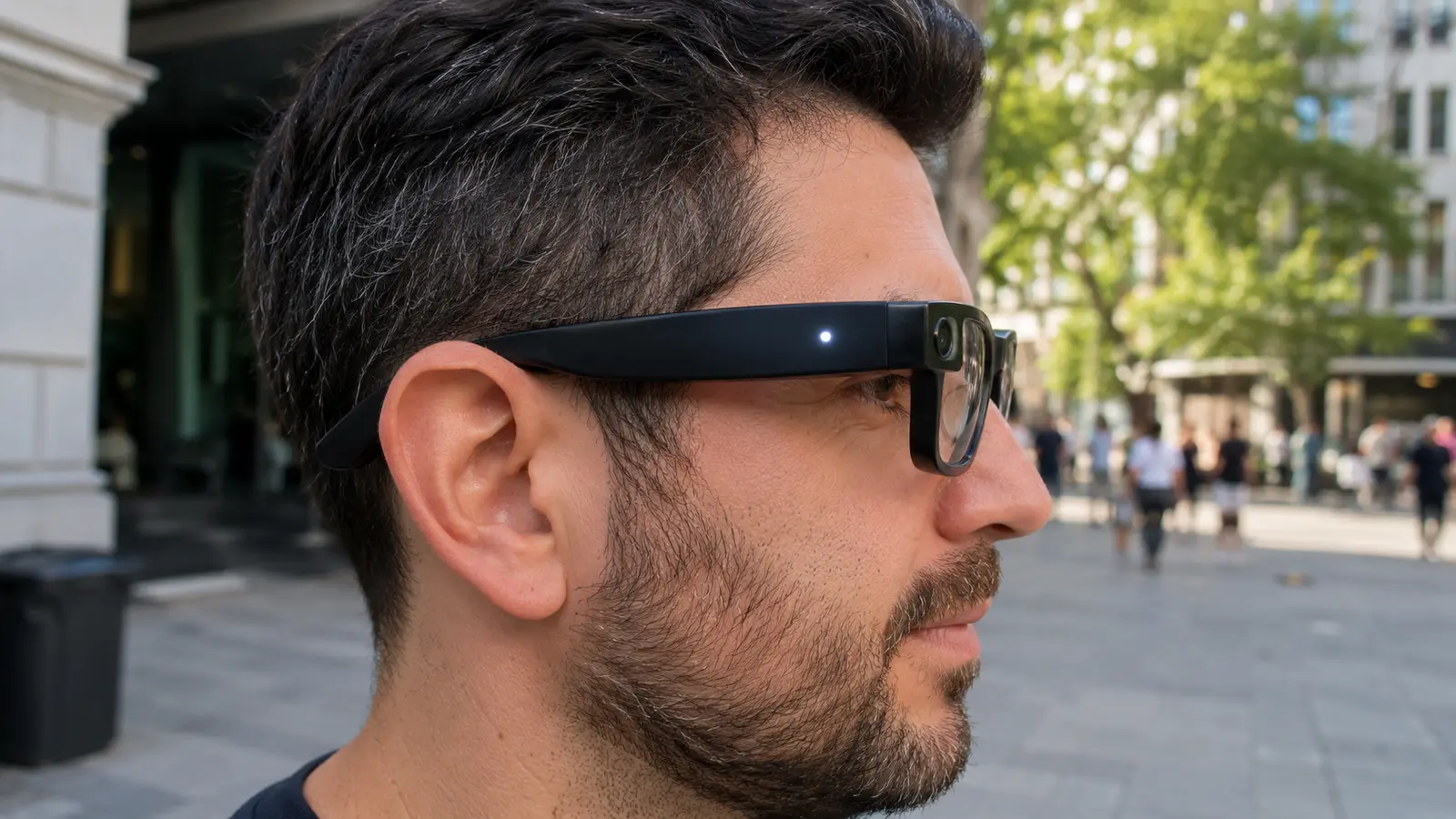 Person wearing camera-equipped smart glasses with a visible white capture light