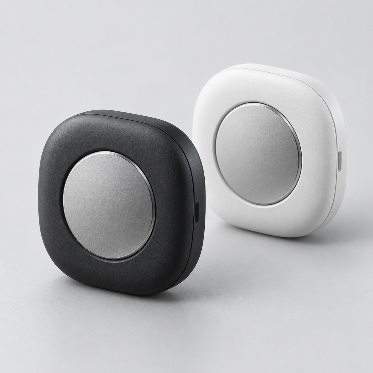 Galaxy SmartTag 3 trackers in black and white with rounded-square design and metallic circular center